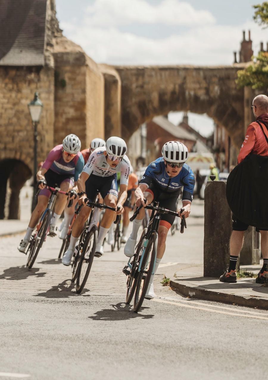 Callum Laborde leading a group through a town-centre corner